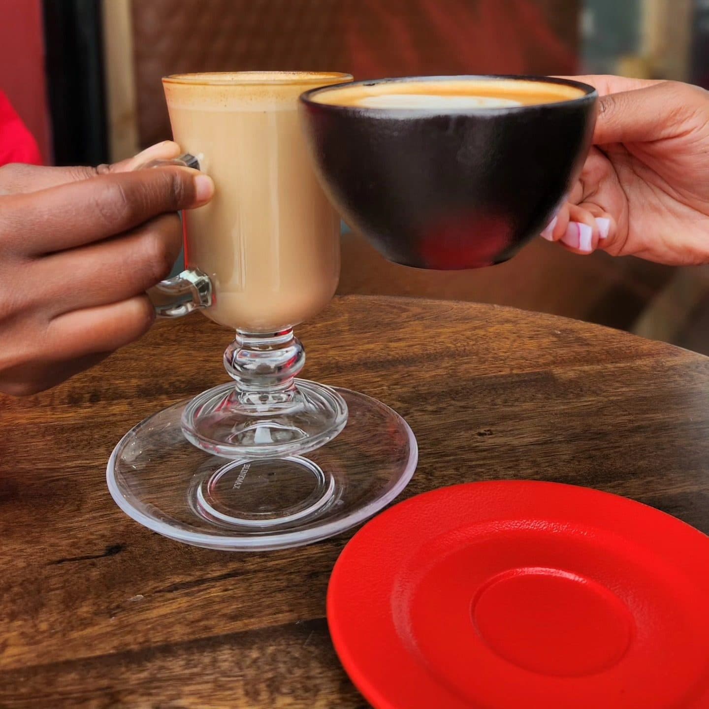 Two cups raised across the table